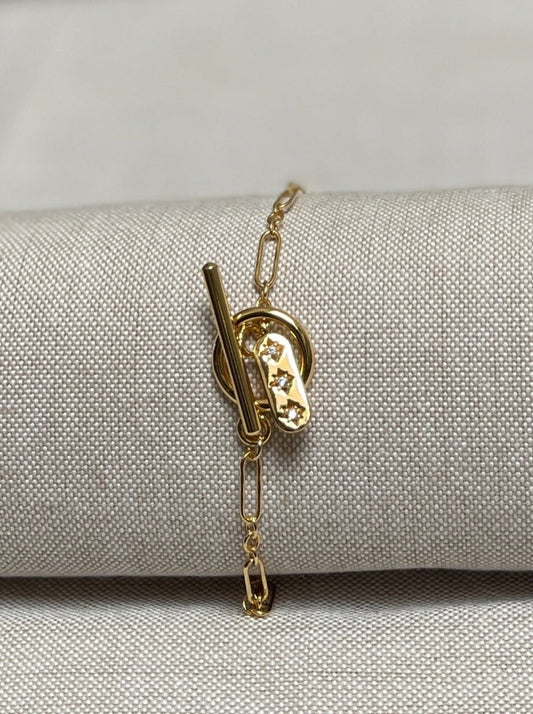 Image of bracelet with toggle clasp and charm. 