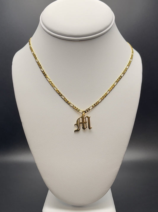 Image of necklace. Chain Length: 20 inches Chain Type:Figaro Chain Thickness: 3.2 mm Clasp: Lobster Charm: 11 X 22 mm Chain:14k Gold-filled over brass Charm:14k Gold-filled over brass