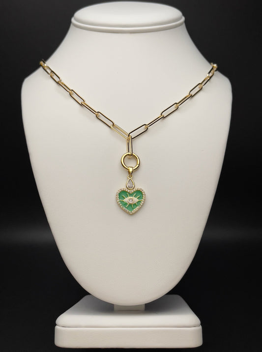 Image of a paperclip chain necklace with green enamel heart evil eye charm. 